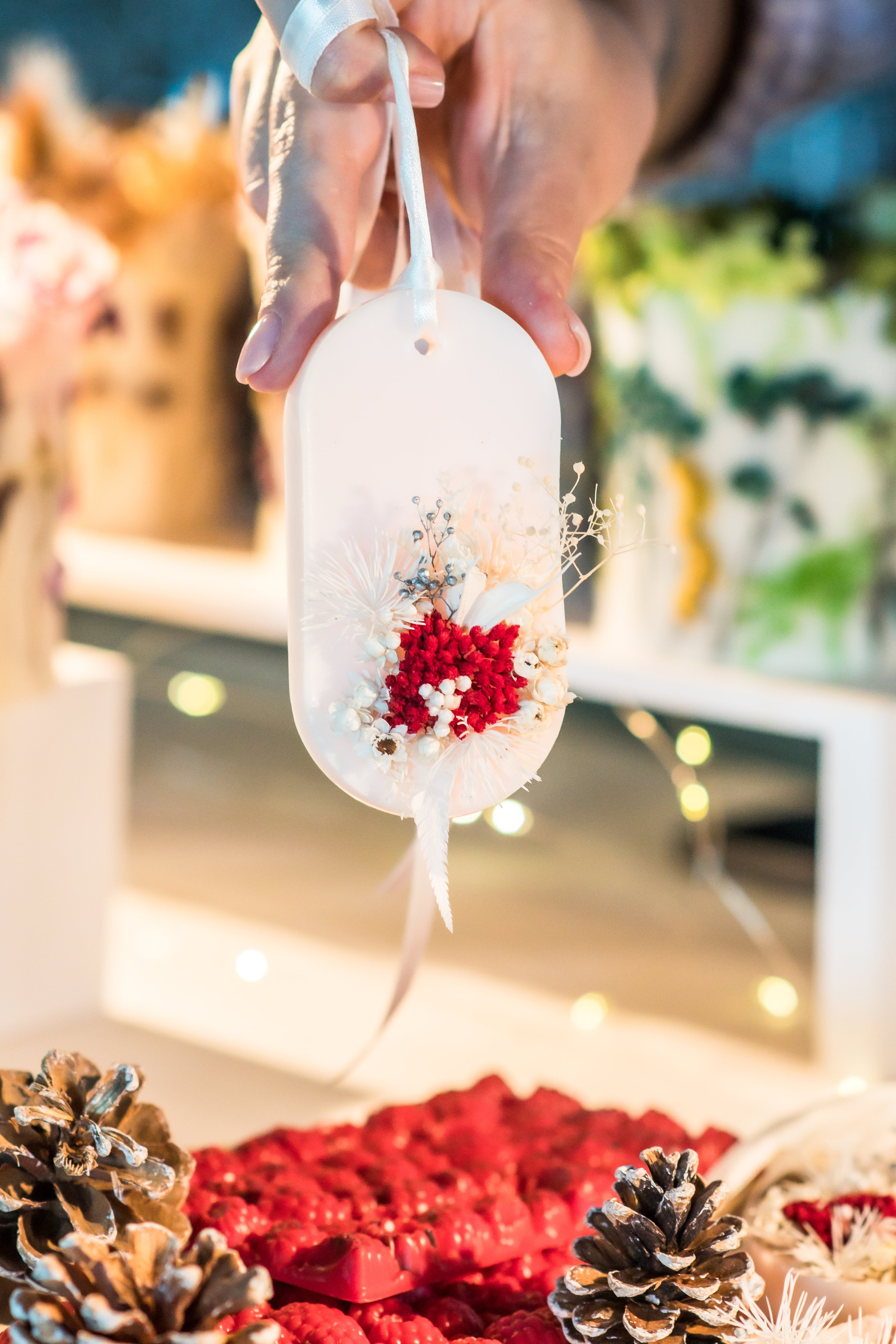 Close-up of decorative wax sachet filled with botanicals and scent