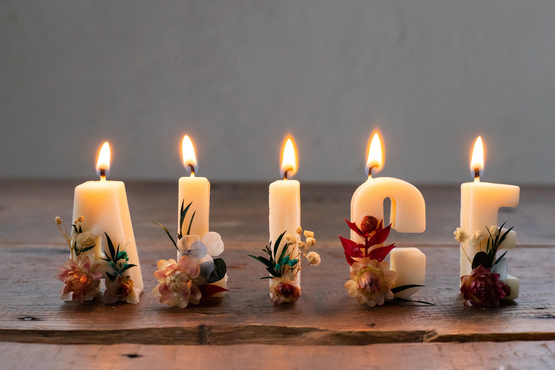 Variety of custom letter candle flower decorations – red, blue, yellow, green