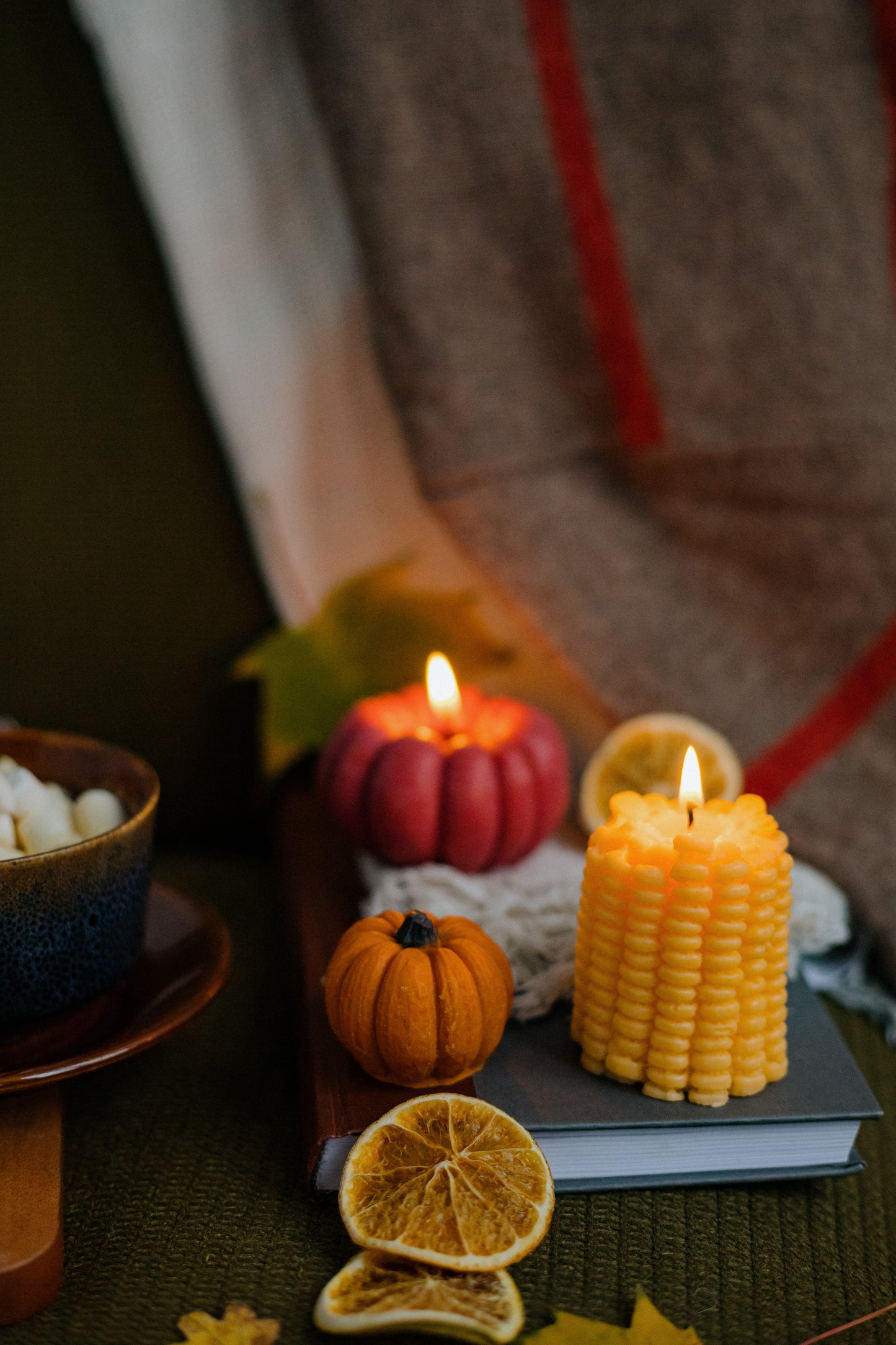 Novelty corn-shaped candle on autumn table—eco-friendly beeswax design